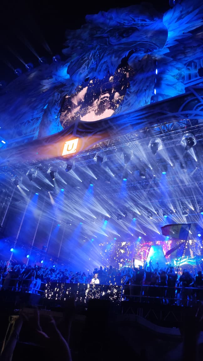 Escenario del festival Untold con luces azules y multitud